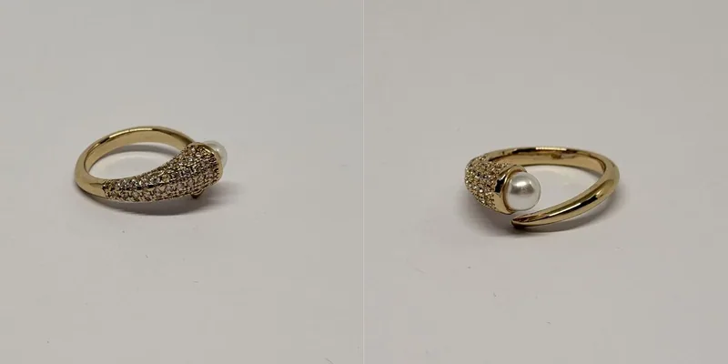 Anel dourado com aros cruzados, um cravejado, e pérola ao centro — ref. ANL0047A