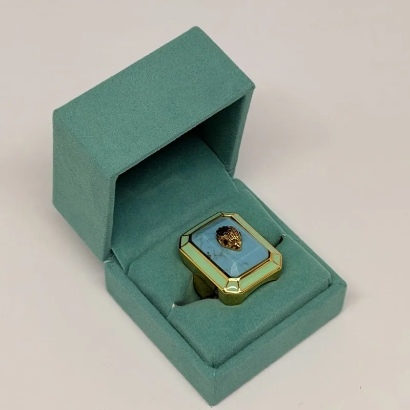 Anel dourado retangular com esmalte azul e detalhe central em cristal — ref. ANQ0132A