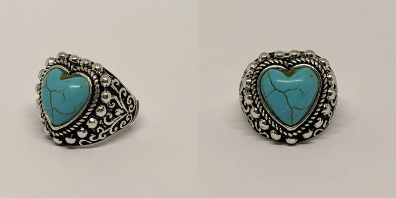 Anel prateado com pedra turquesa em formato de coração e moldura de esferas — ref. ANL0097A